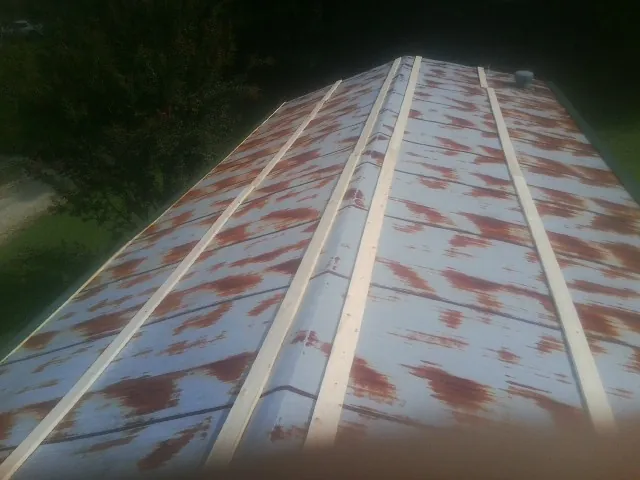 Rusted metal roof panels with new wood purlins before replacement — Storm Damage Roof Repair in Egg Harbor Township by Roofing Brothers