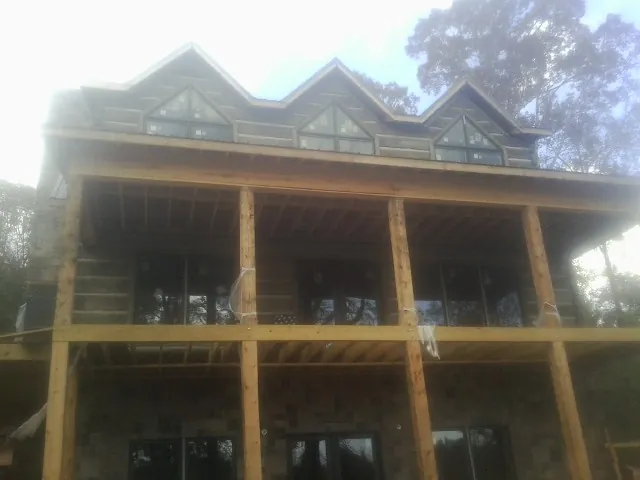 Dormers and porch framing on a large log home under construction — Roof Coating work by our crew in Egg Harbor Township