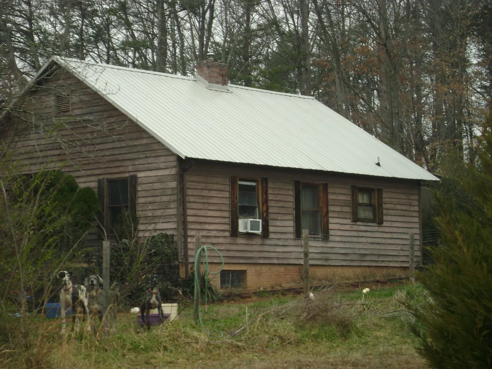 White metal roof on an old wood sided farmhouse, from a Metal Roof Installation job in Egg Harbor Township